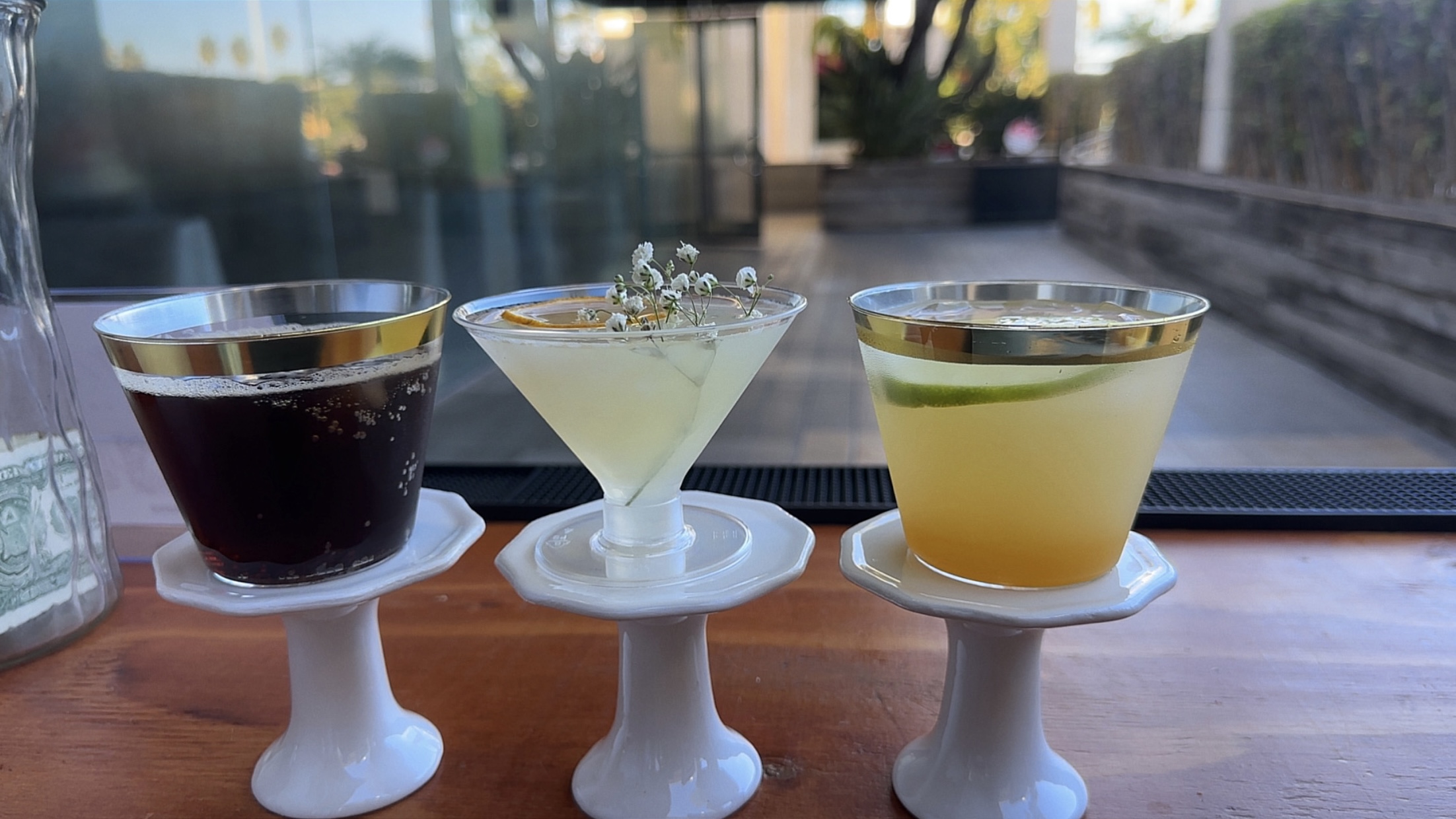 She Pours branded business card on the bar between bowls of grapefruit, babies-breath flowers, and lime slices.